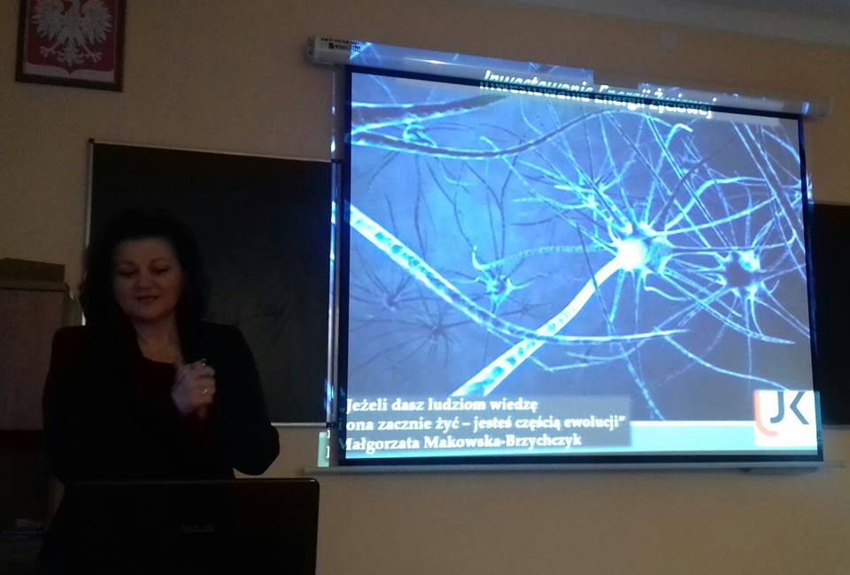 Małgorzata Makowska podczas wykładu otwartego na tle ekranu projekcyjnego
